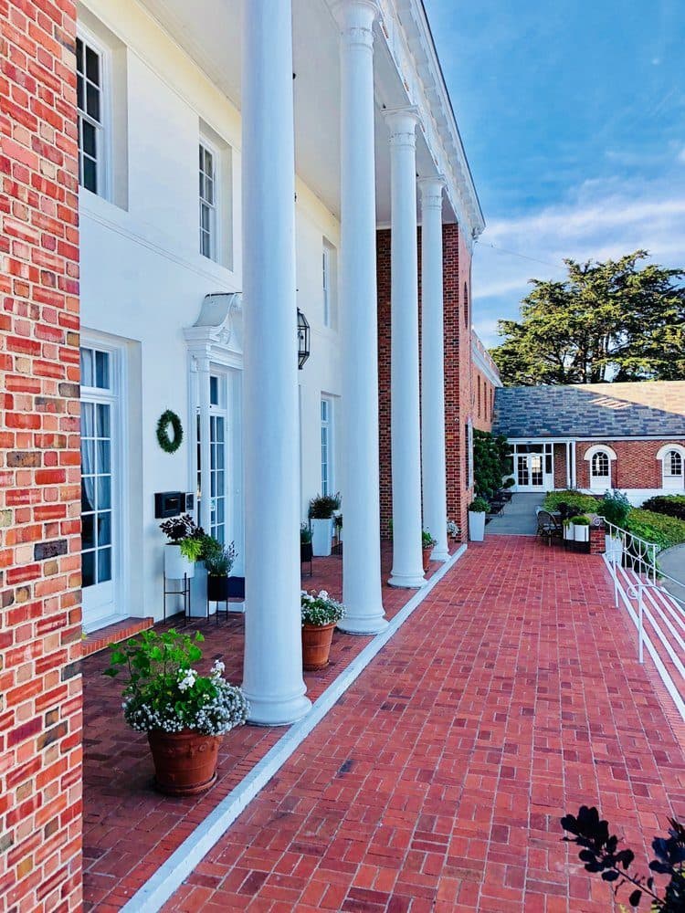 The columned front entrance and brick walkway