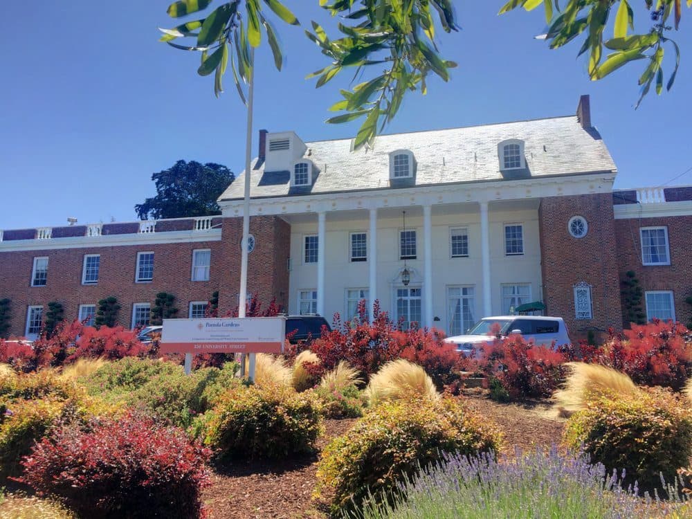 The 1930s Colonial Revival building and front garden at Portola Gardens