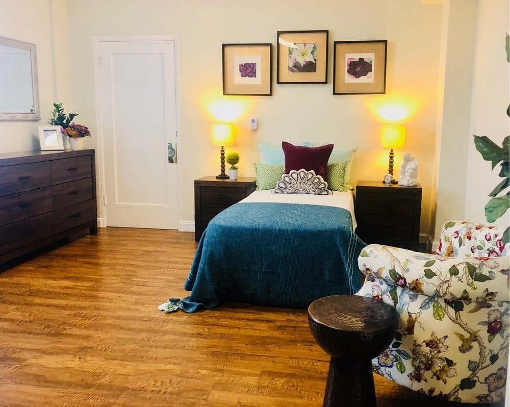 A resident room, furnished and light-filled